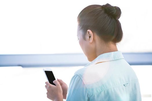 Rear view of a businesswoman using her smartphone