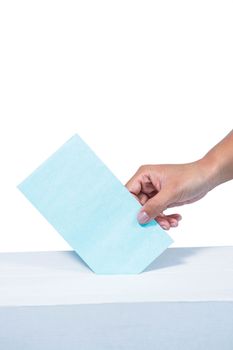 Businesswoman putting ballot in vote box
