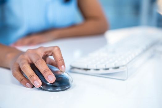 Cropped image of businesswoman using mouse
