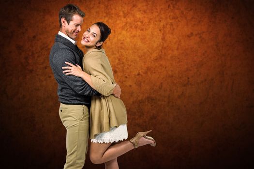 Composite image of full length of romantic couple hugging