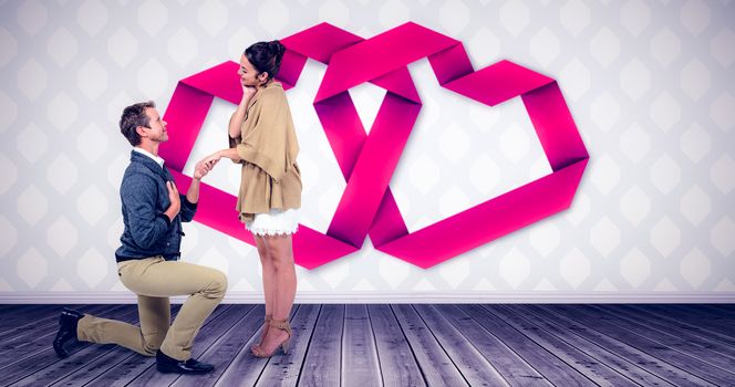 Composite image of handsome man proposing woman while kneeling