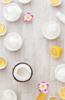 Coconut oil and lemon juice, still life pattern background. Natural ingredient spa treatment, overhead view