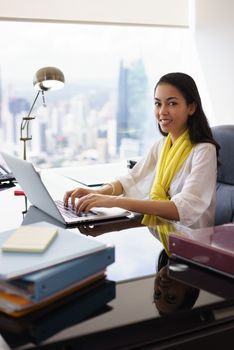 Business Woman Assistant Smiles At Camera Typing On PC