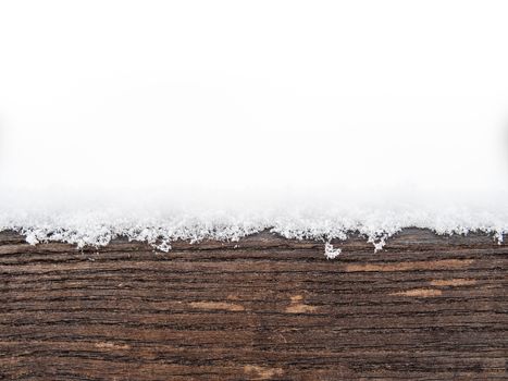 Painted wooden board or timber covered with snow