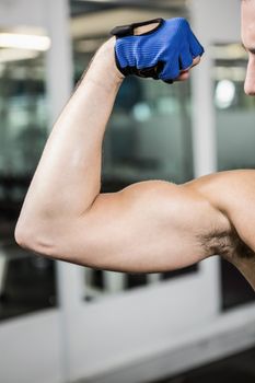 Muscular man showing biceps