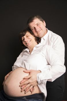 Mature pregnant mother and senior father