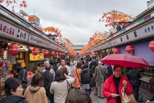 Tourists shop souvenir street at Senso-ji Temple
