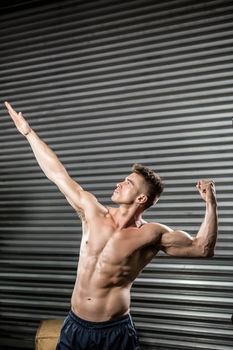 Shirtless man flexing muscles
