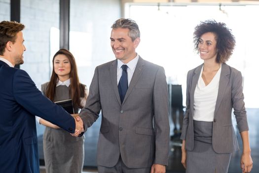 Businessman shaking hands with team