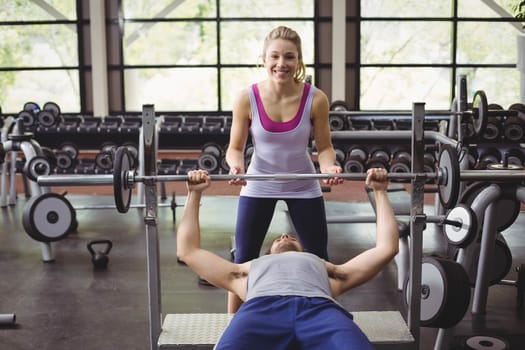 Trainer woman helping athletic man