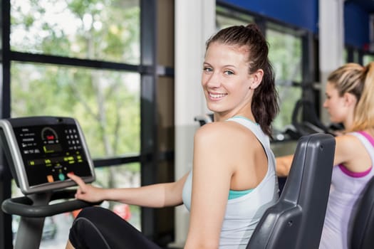 Fit woman doing exercise bike