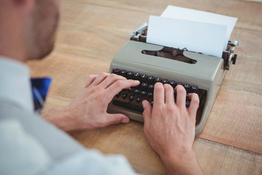 masculine hands typing on old typewriter