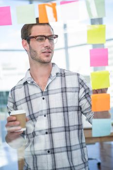 Hipster man looking at post-it
