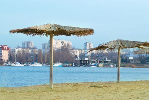 Sea coast with beach straw umbrellas