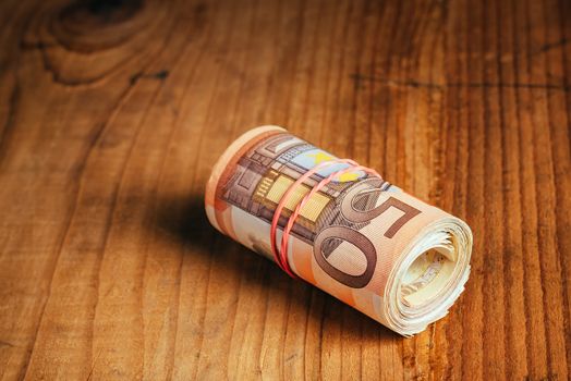 Rolled up cash money, euro banknotes