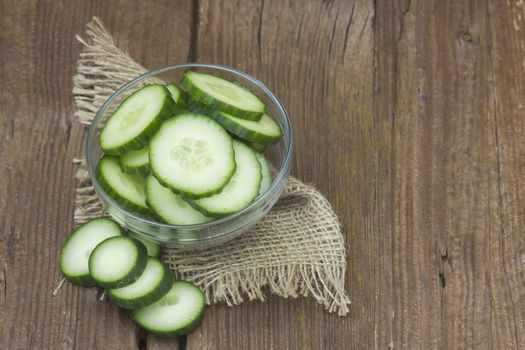 fresh sliced cucumbers on an old wooden table