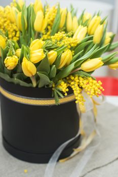 Bright spring bouquet of tulips and mimosa flowers