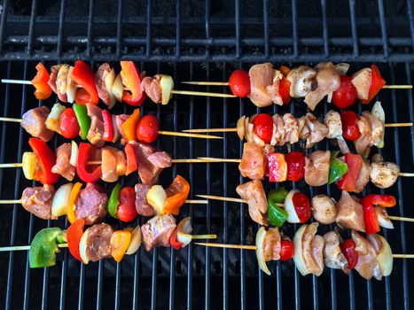Barbecue grill with meat and vegetable skewers