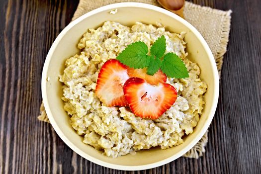 Oatmeal with strawberries on sacking top