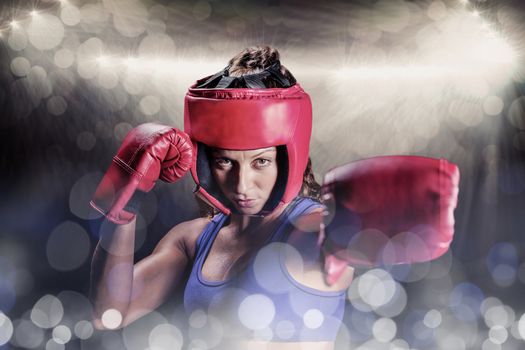 Composite image of portrait of female boxer with gloves and headgear