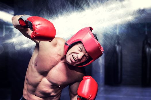 Composite image of aggressive boxer against black background