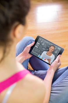 Woman using tablet at home against front view of a black woman looking at camera