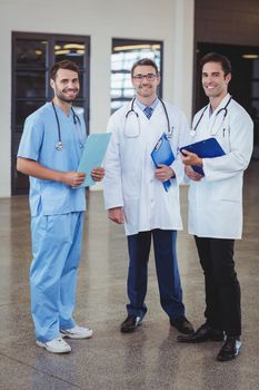 Portrait of smiling doctors holding clipboards