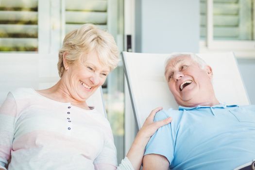 Happy senior couple relaxing on lounge chair