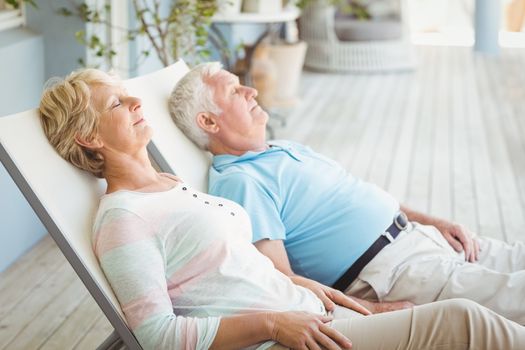 Senior couple relaxing on lounge chair