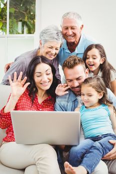 Happy multi generation family using laptop