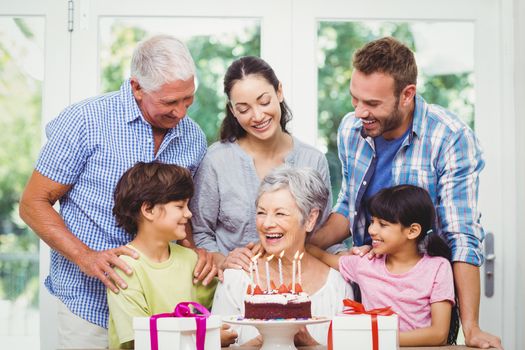 Smiling family with grandparents during birthday party 