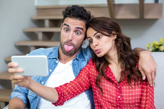 Couple making faces while taking selfie 