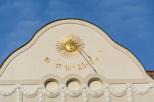 Sundial clock on a house facade