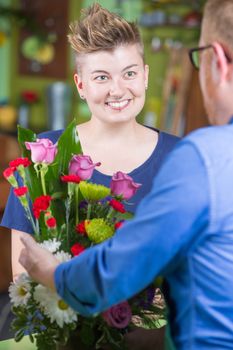 Attractive Woman in Flower Shop Purchases Arrangement