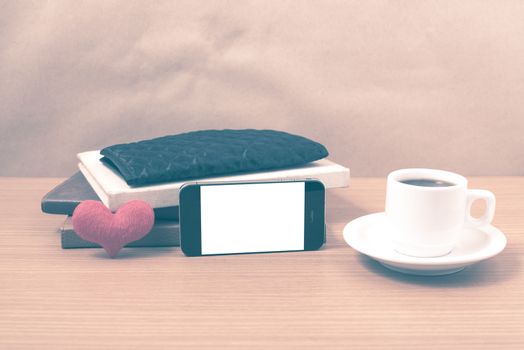 working table : coffee with phone,stack of book,wallet and heart