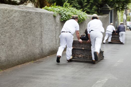 raditional downhill sledge trip on May 20, 2015 in Madeira, Portugal. Sledges were used as local transport. Currently these Toboggan riders are a touristic attraction