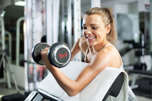 Young woman doing Biceps exercise