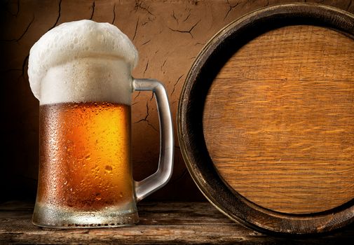 Frothy beer and barrel