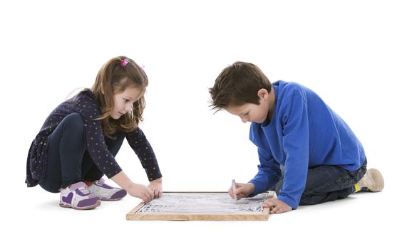 children drawing on chalk board