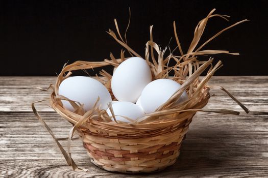 White chicken eggs in basket