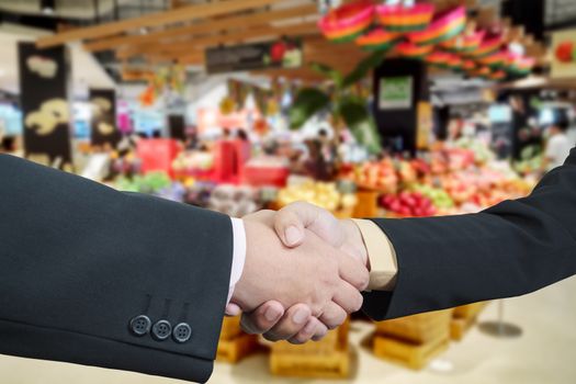 Business handshake with blur background of shopping mall market