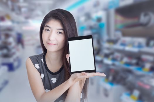 Young Asian woman show or display tablet with blank screen on sh
