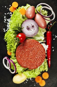Raw Ground beef meat Burger steak cutlets with seasoning and veg