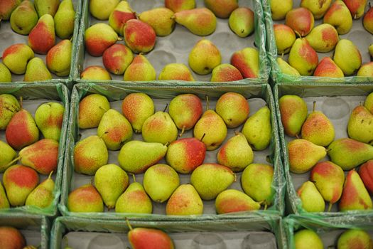 background of ripe juicy pears in market