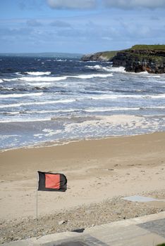 quicksilver flag flying beside ballybunion beach