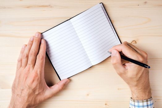 Man writing notes in notebook