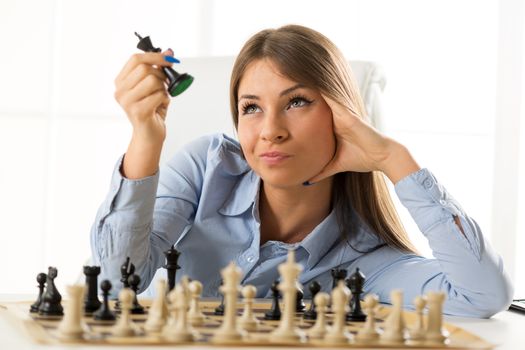 Young Pretty Businesswoman With Chessmen