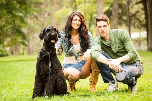 Young Couple With Giant Schnauzer