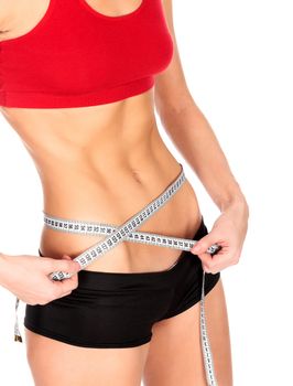 Slim woman measures her waistline