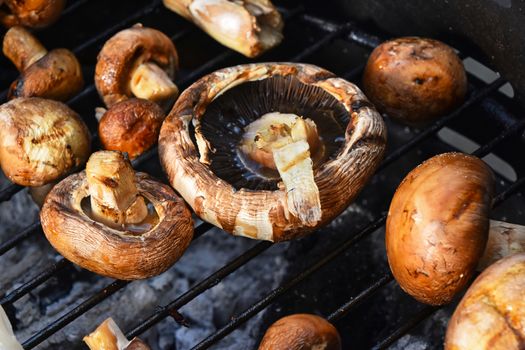 Brown champignons mushrooms on grill